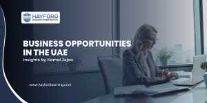 Banner for Hayford Integrated Training Institute featuring a professional woman working on a laptop in a modern office. Text reads “Business Opportunities in the UAE – Insights by Komal Jajoo” with the Hayford logo and website URL displayed on a blue-toned background.